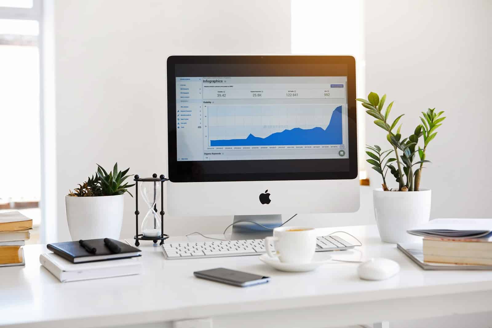 Desk with notebook and computer screen showing accounting software.