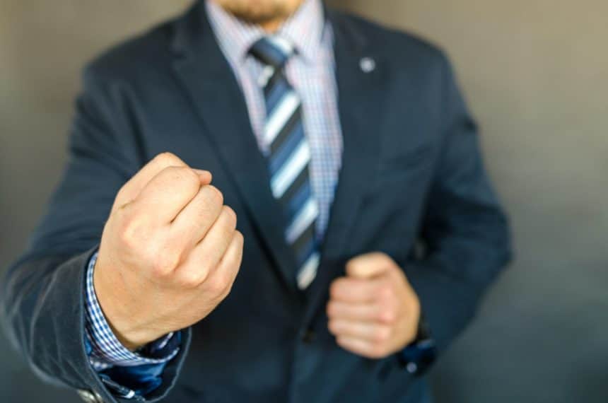 Person in suit with clenched fist