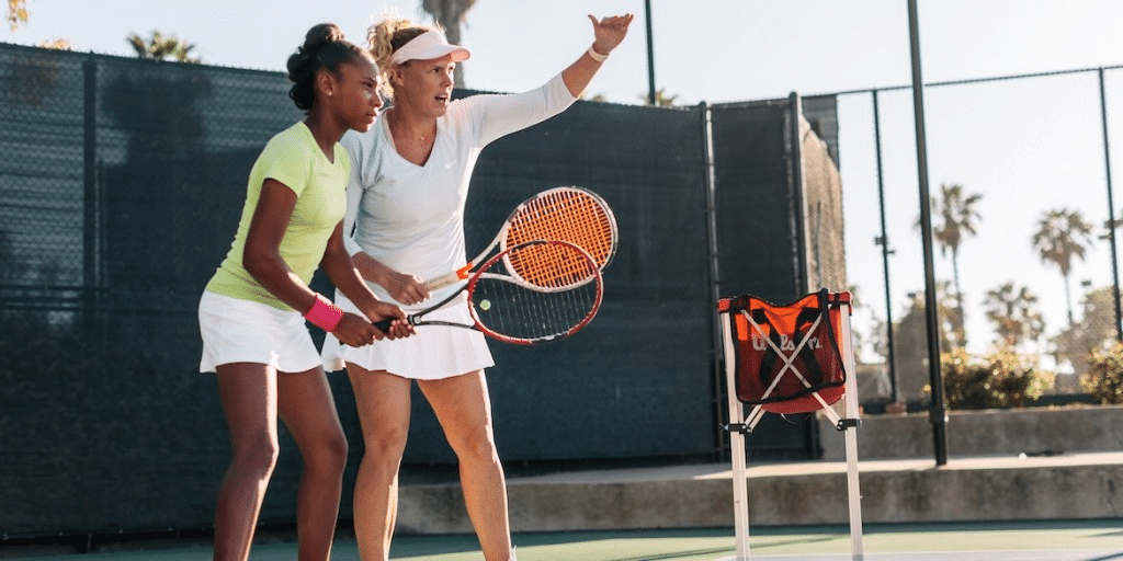 two women playing tennis doubles